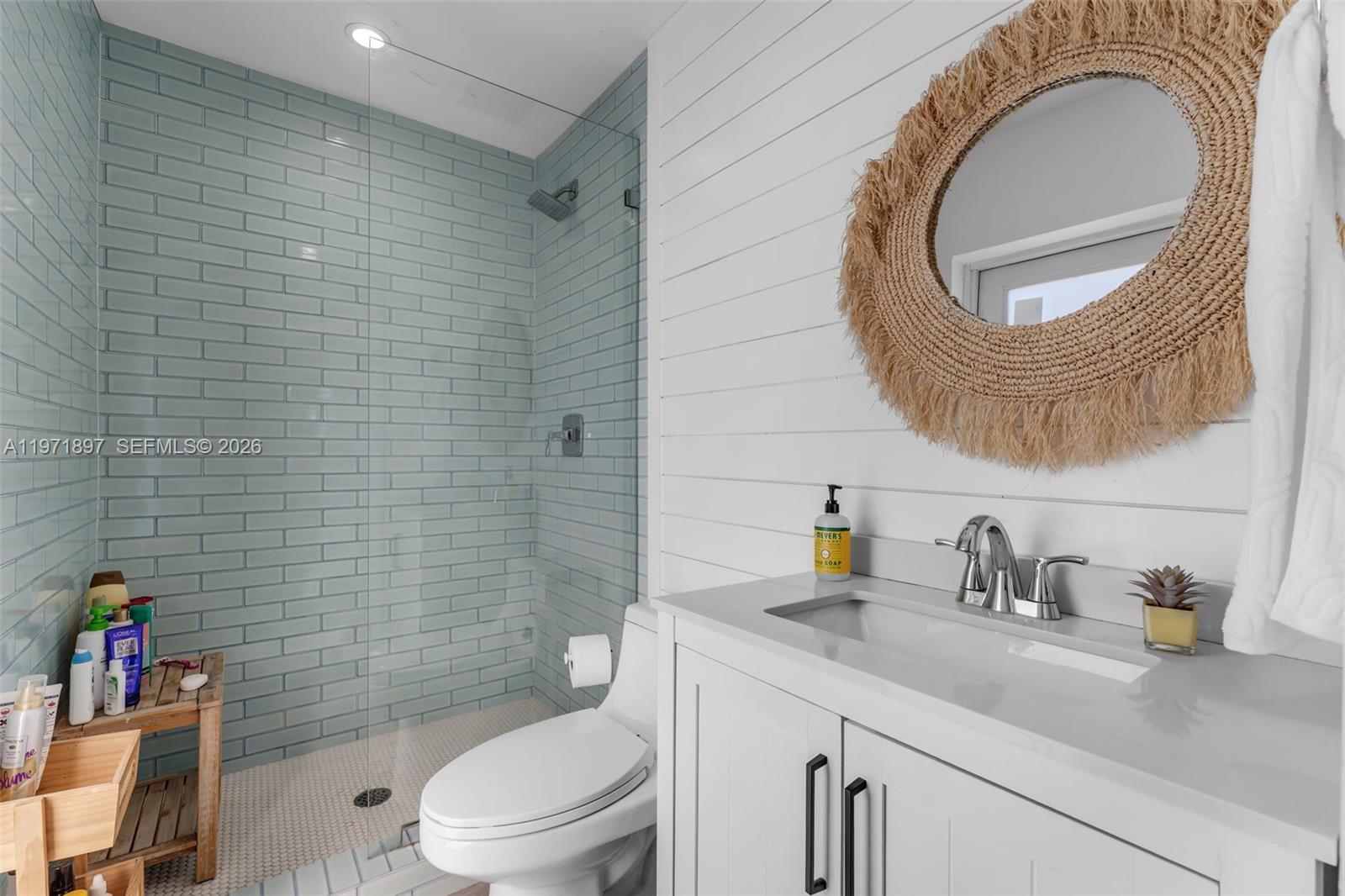 8311 Southwest 47th Street Miami, FL 33155 - Photo 21 of 48 a bathroom with a toilet a sink a mirror and shower