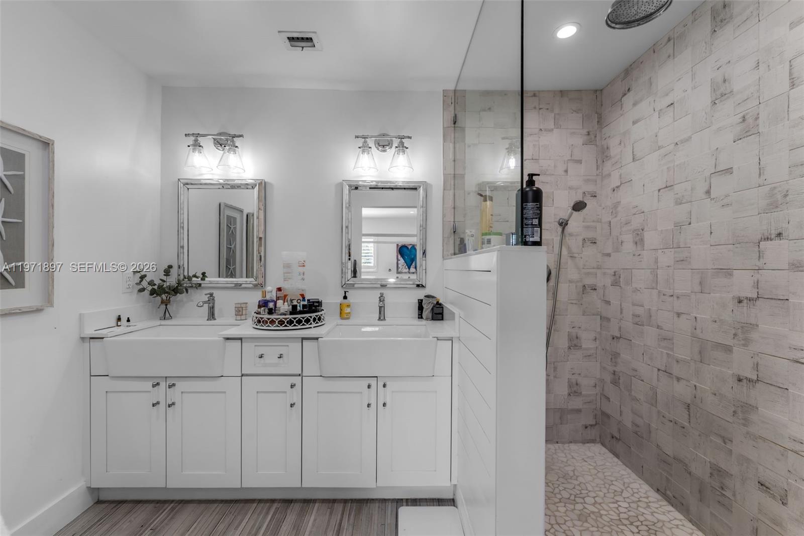 8311 Southwest 47th Street Miami, FL 33155 - Photo 25 of 48 a bathroom with a sink a vanity a mirror and shower