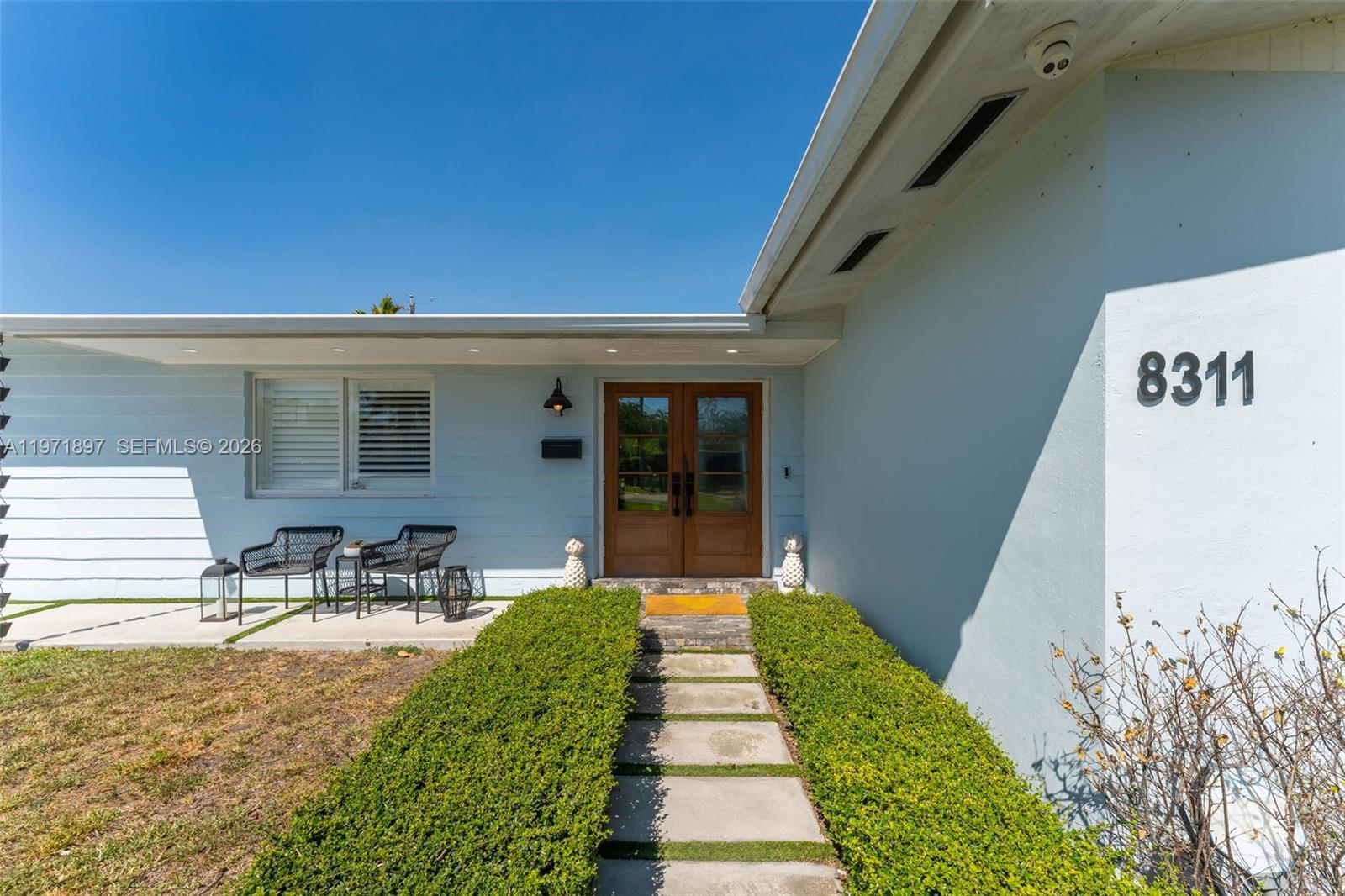 8311 Southwest 47th Street Miami, FL 33155 - Photo 3 of 48 a front view of a house with outdoor seating