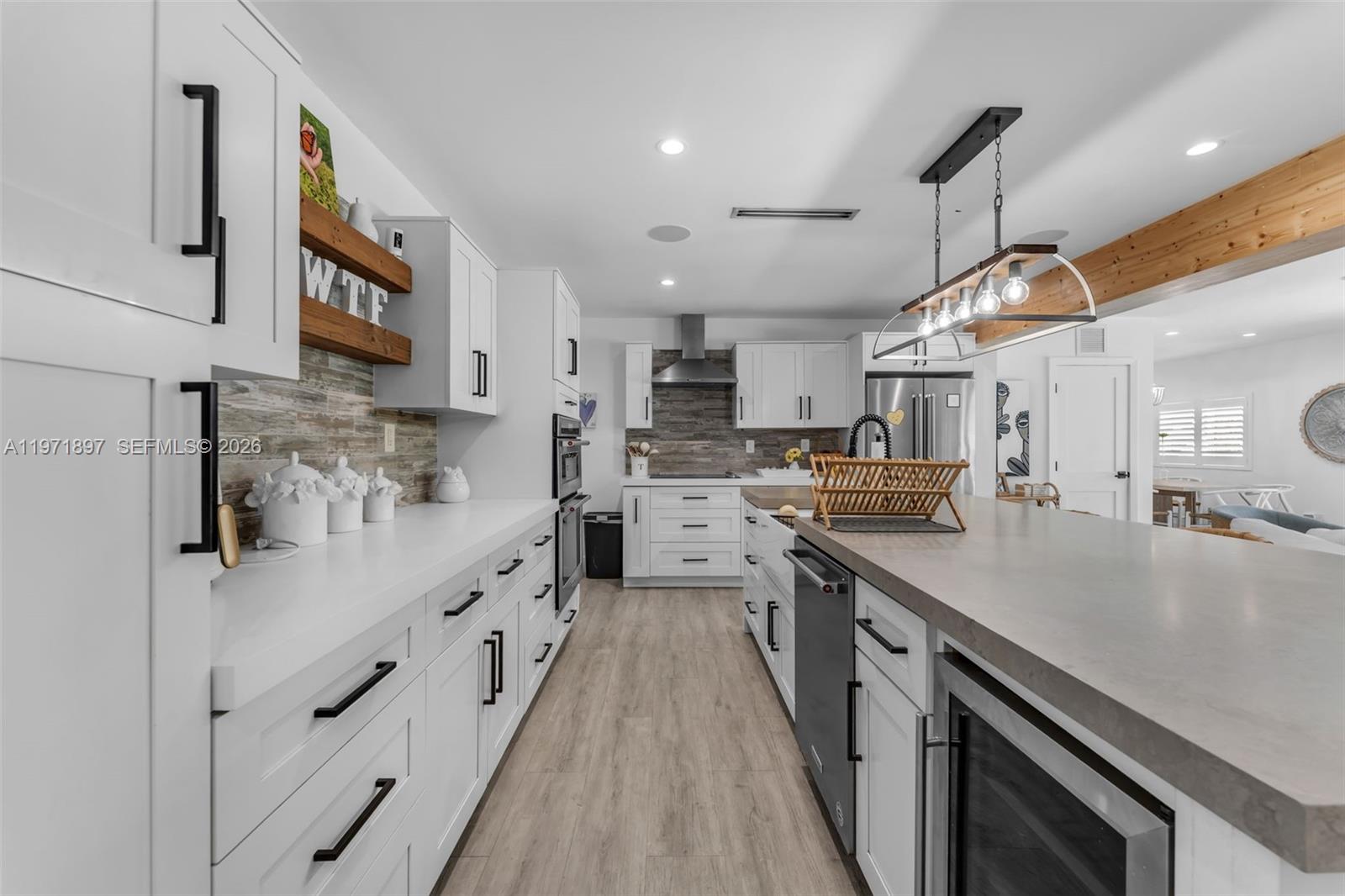 8311 Southwest 47th Street Miami, FL 33155 - Photo 6 of 48 a kitchen with stainless steel appliances lots of counter space cabinets and wooden floor