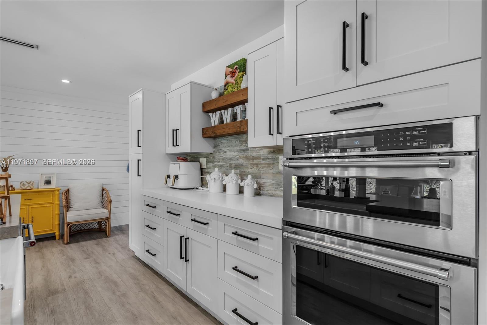8311 Southwest 47th Street Miami, FL 33155 - Photo 8 of 48 a kitchen with stainless steel appliances a stove and white cabinets