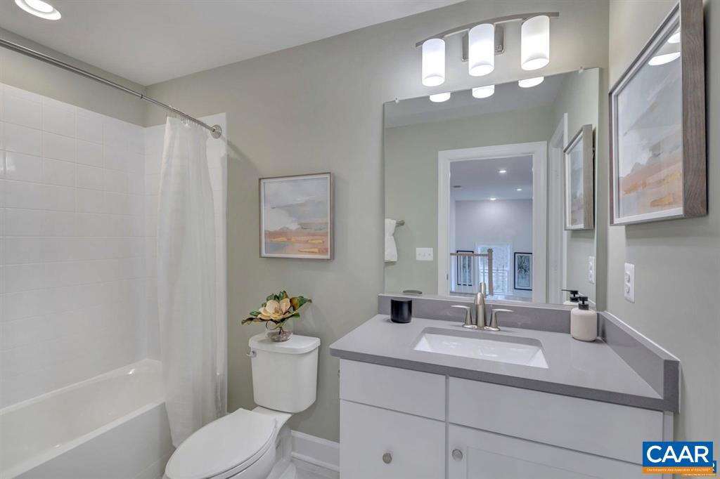 2837 Rambling Brook Lane Crozet, VA 22932 - Photo 22 of 24 a bathroom with a sink a toilet a mirror a vanity and shower