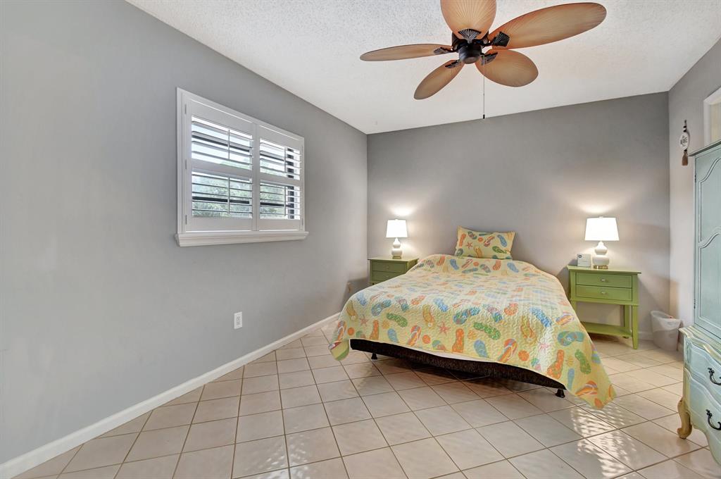 9220 Southwest 14th Street, Unit 3304 Boca Raton, FL 33428 - Photo 11 of 46 a bedroom with a bed and window