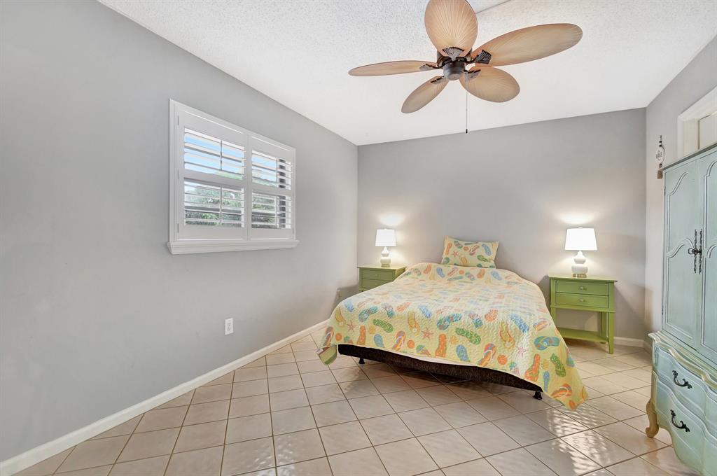 9220 Southwest 14th Street, Unit 3304 Boca Raton, FL 33428 - Photo 12 of 46 a bedroom with a bed and a ceiling fan