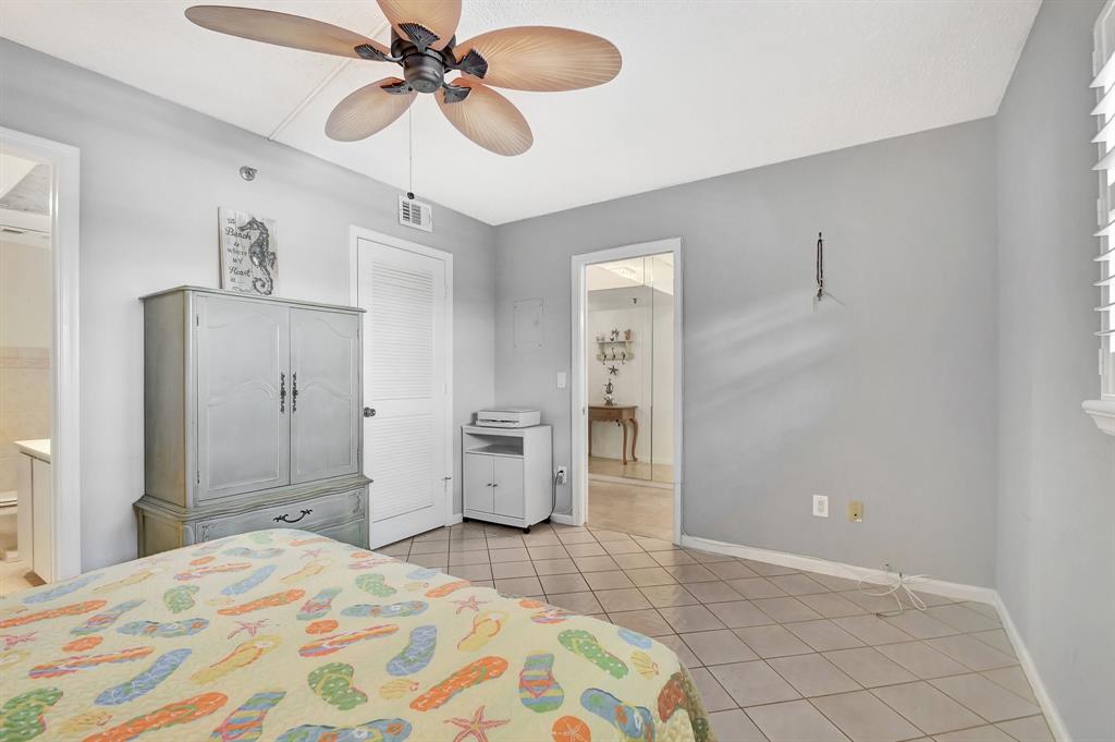 9220 Southwest 14th Street, Unit 3304 Boca Raton, FL 33428 - Photo 13 of 46 a bedroom with a bed and cabinets