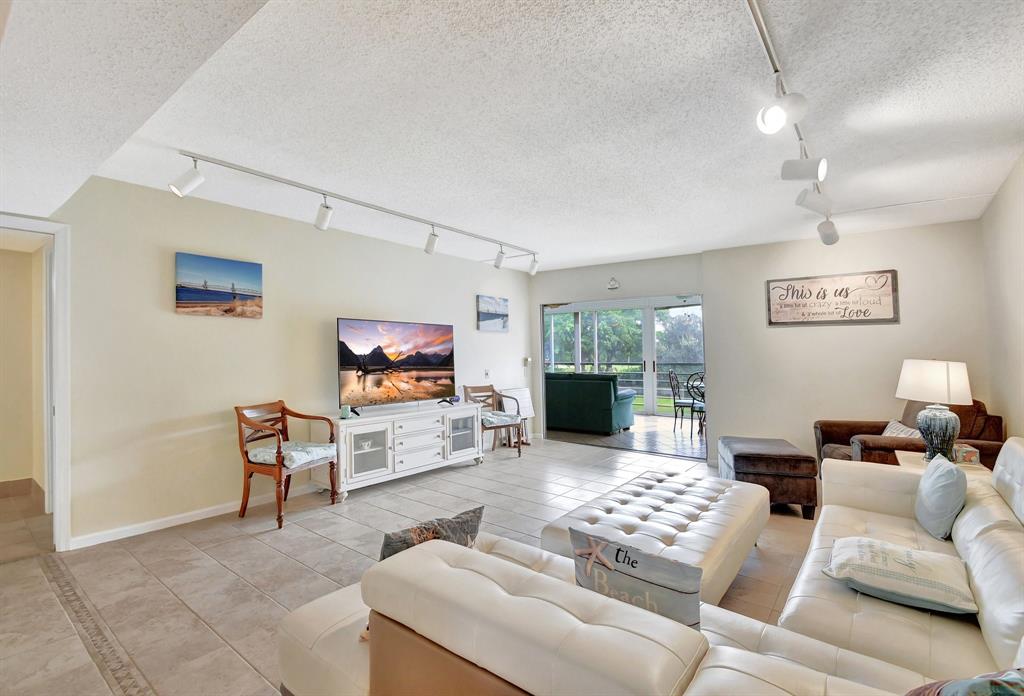 9220 Southwest 14th Street, Unit 3304 Boca Raton, FL 33428 - Photo 19 of 46 a living room with furniture and a flat screen tv