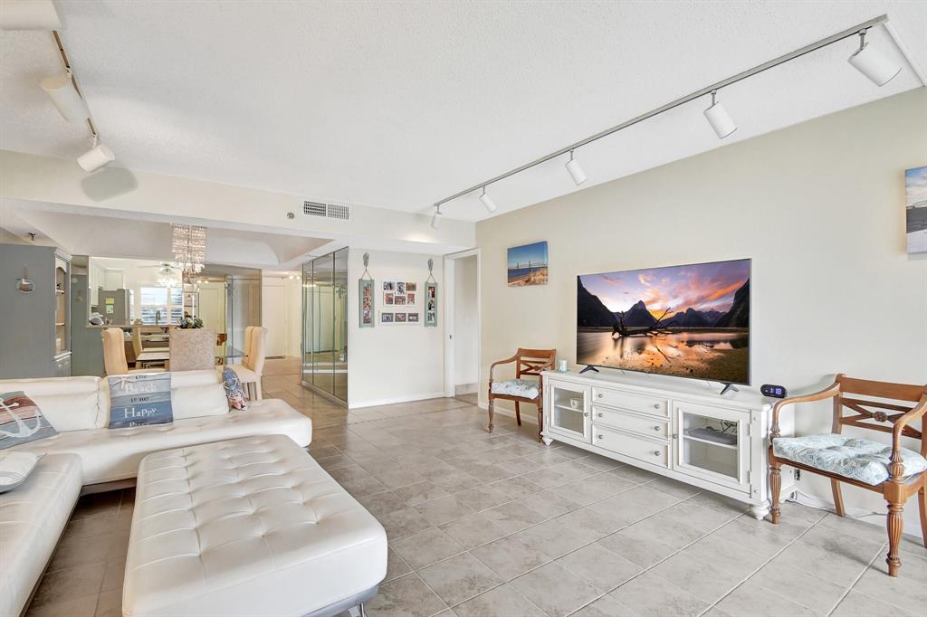 9220 Southwest 14th Street, Unit 3304 Boca Raton, FL 33428 - Photo 22 of 46 a living room with furniture and a flat screen tv
