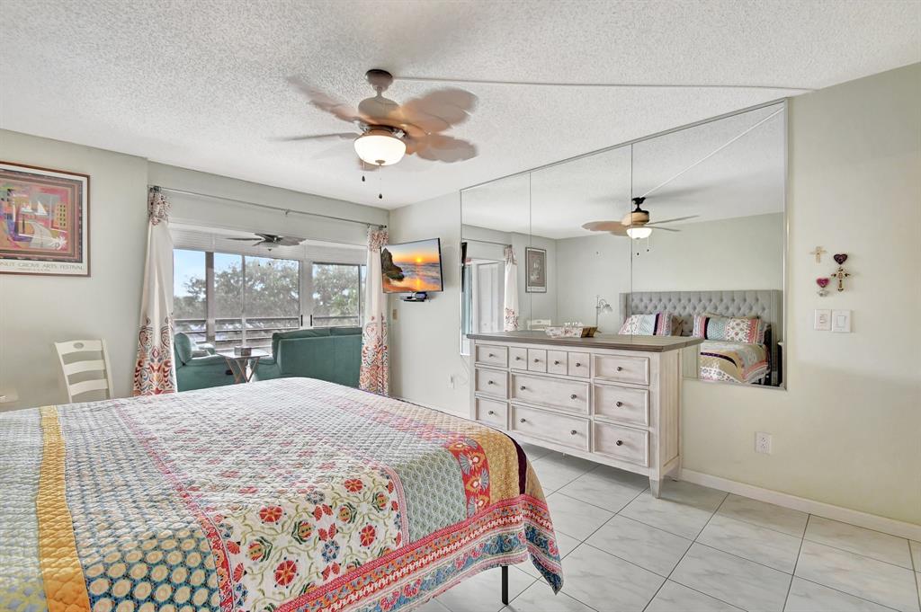 9220 Southwest 14th Street, Unit 3304 Boca Raton, FL 33428 - Photo 24 of 46 a bedroom with a bed and a dresser