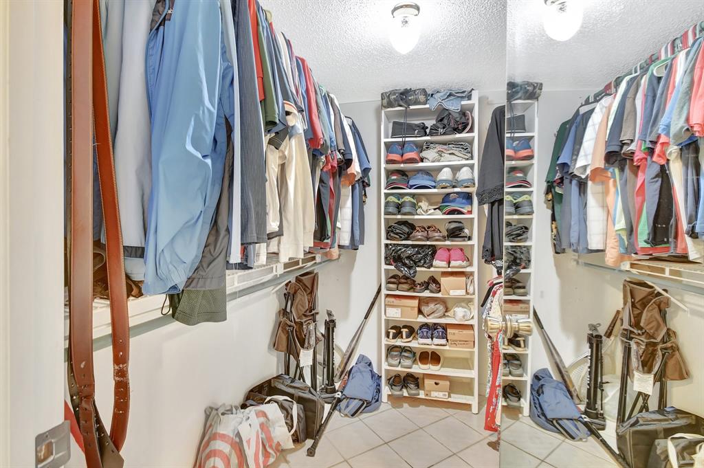 9220 Southwest 14th Street, Unit 3304 Boca Raton, FL 33428 - Photo 26 of 46 a view of walk in closet with clothes and shoes