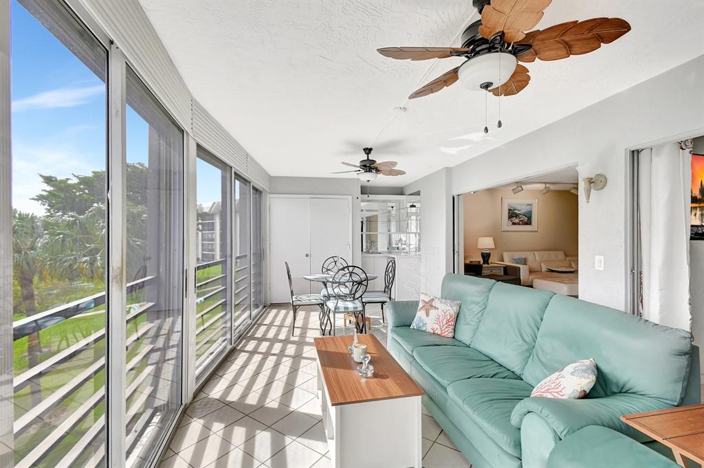 9220 Southwest 14th Street, Unit 3304 Boca Raton, FL 33428 - Photo 28 of 46 a living room with furniture and a large window