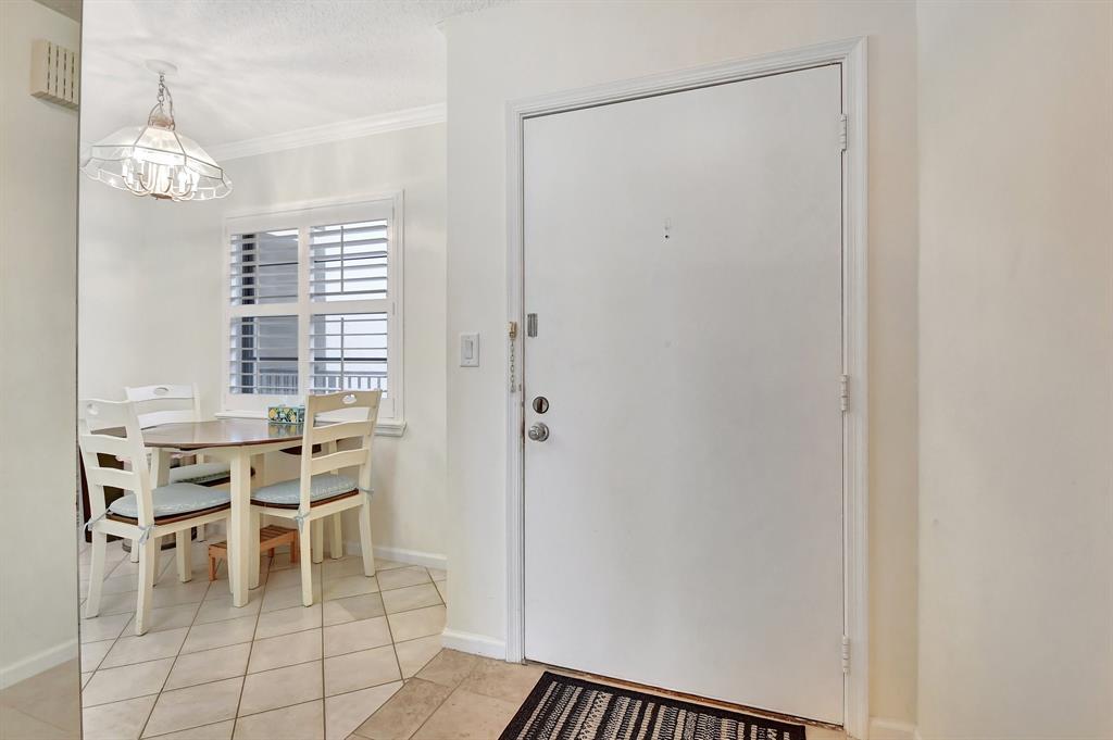 9220 Southwest 14th Street, Unit 3304 Boca Raton, FL 33428 - Photo 5 of 46 a dining room with furniture a chandelier and a window