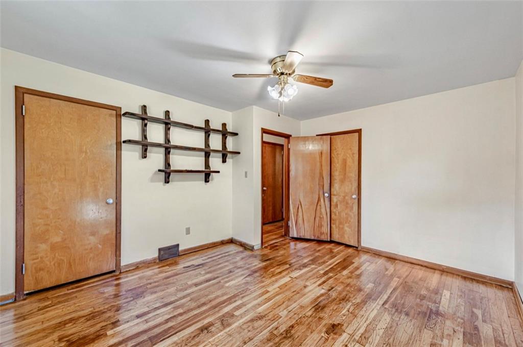 121 Sampson Drive Apollo, PA 15613 - Photo 12 of 33 an empty room with wooden floor fan and windows