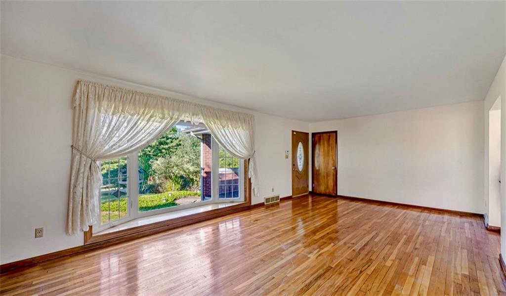 121 Sampson Drive Apollo, PA 15613 - Photo 5 of 33 a view of an empty room with wooden floor and a window