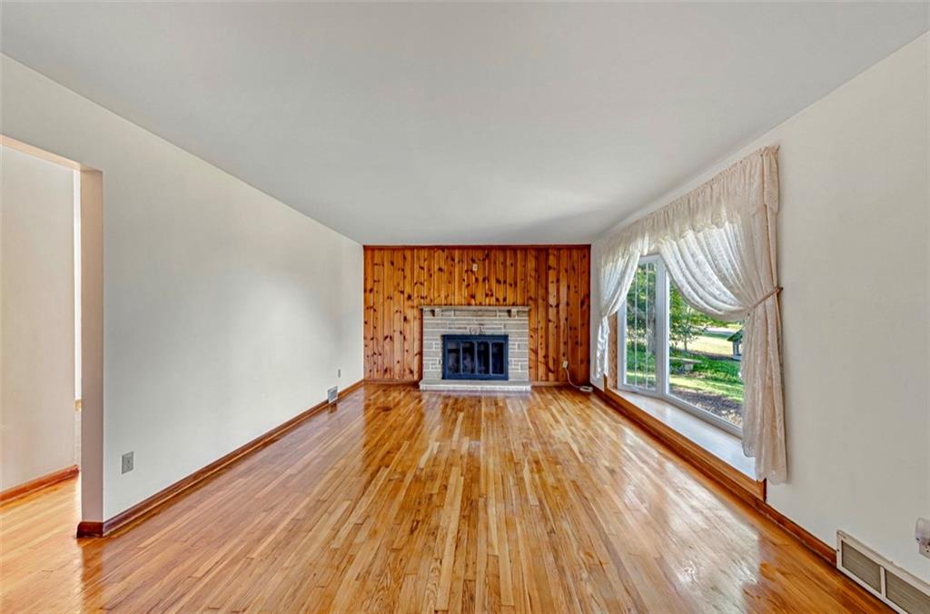 121 Sampson Drive Apollo, PA 15613 - Photo 6 of 33 a view of an empty room with a window and wooden floor