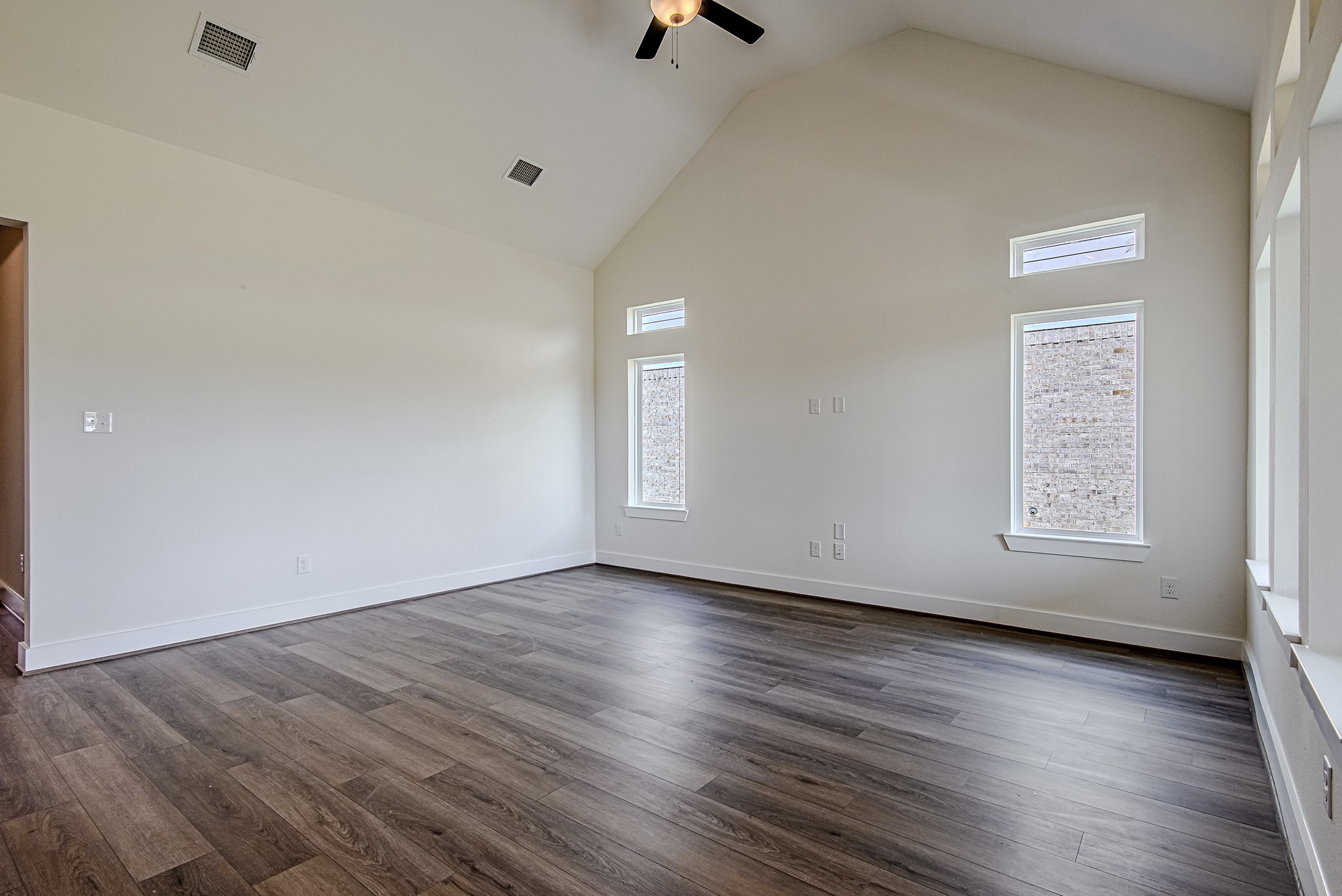 157 Peninsula Point Drive Montgomery, TX 77356 - Photo 12 of 33 an empty room with wooden floor cabinet and windows