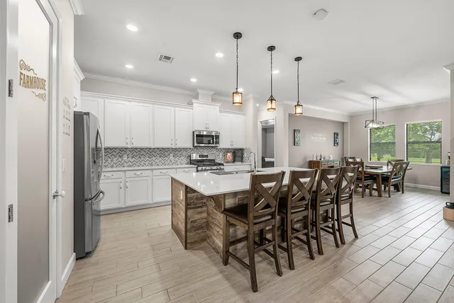 a large kitchen with a table and chairs
