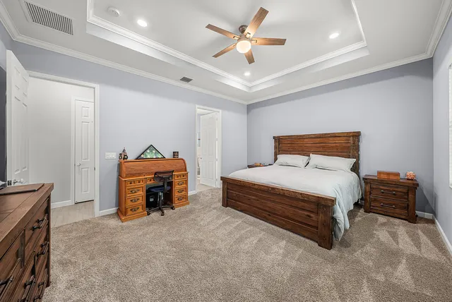 a bedroom with a bed and a chandelier