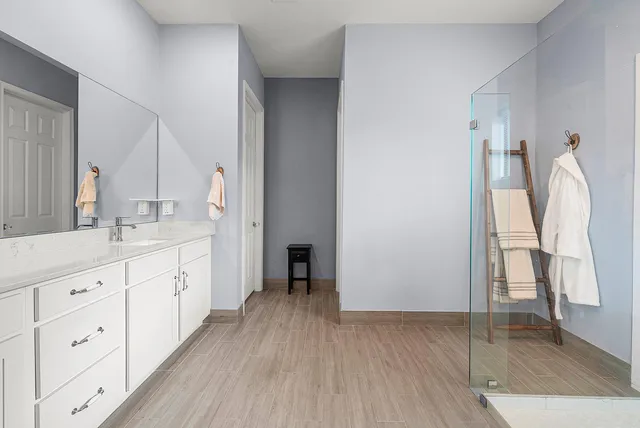 a spacious bathroom with a double vanity sink and a mirror