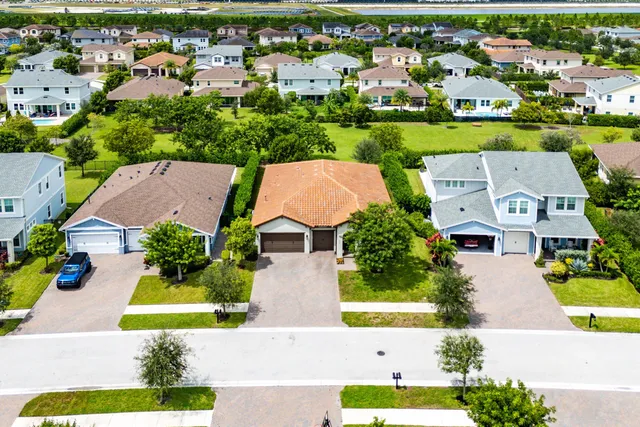 an aerial view of residential houses with outdoor space and swimming pool
