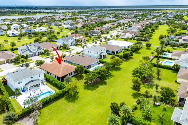 an aerial view of residential houses with outdoor space and swimming pool