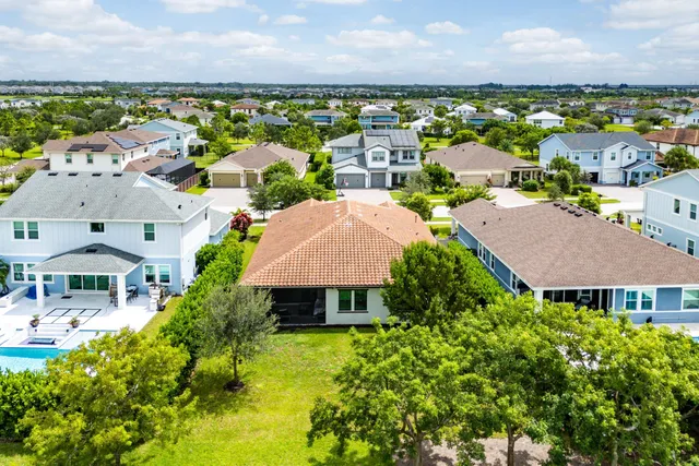 an aerial view of residential houses with yard