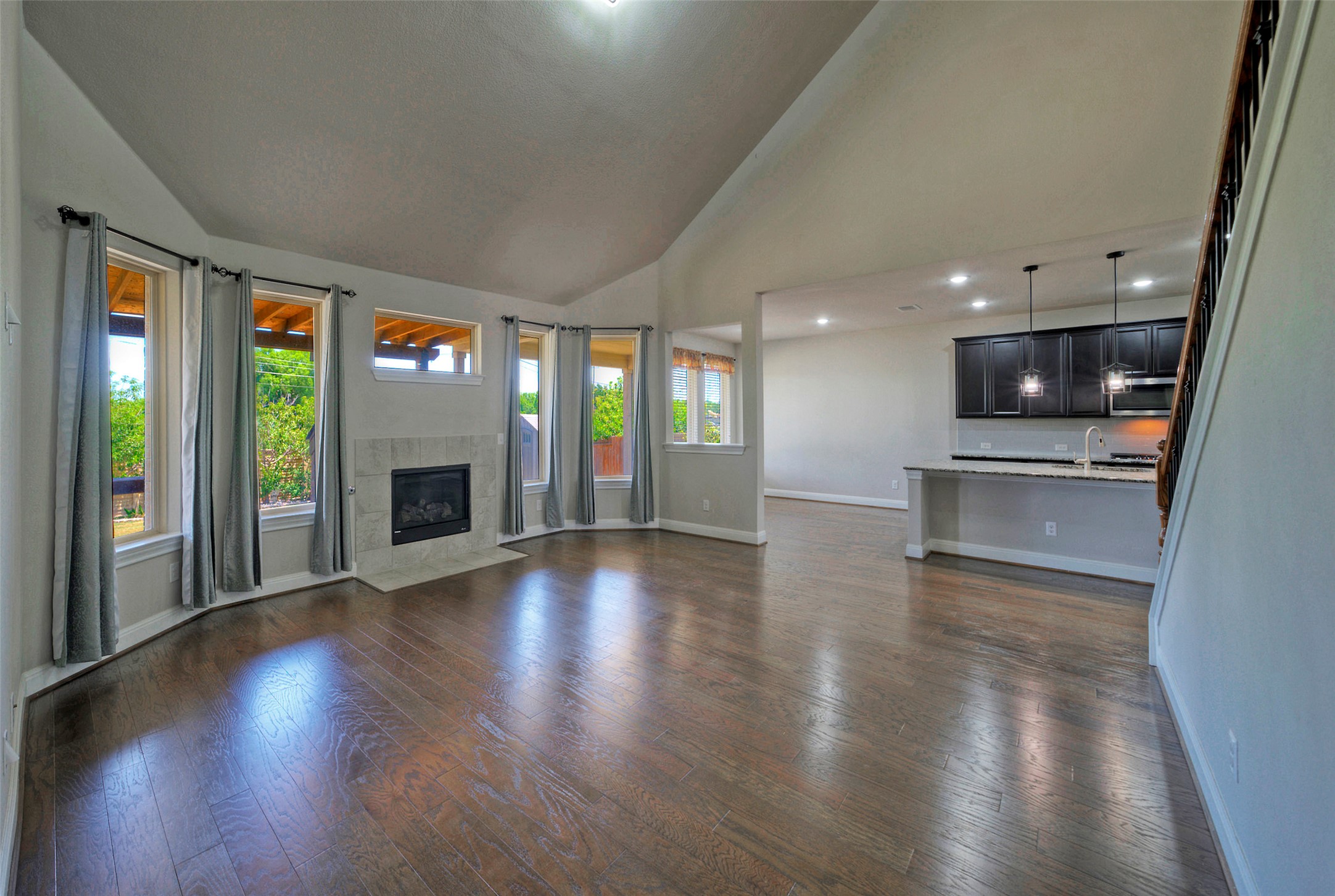 2260 Hat Bender Loop Round Rock, TX 78664 - Photo 18 of 40 Vast vaulted ceilings complement rich hardwood floors and an inviting fireplace in this open-concept living space.