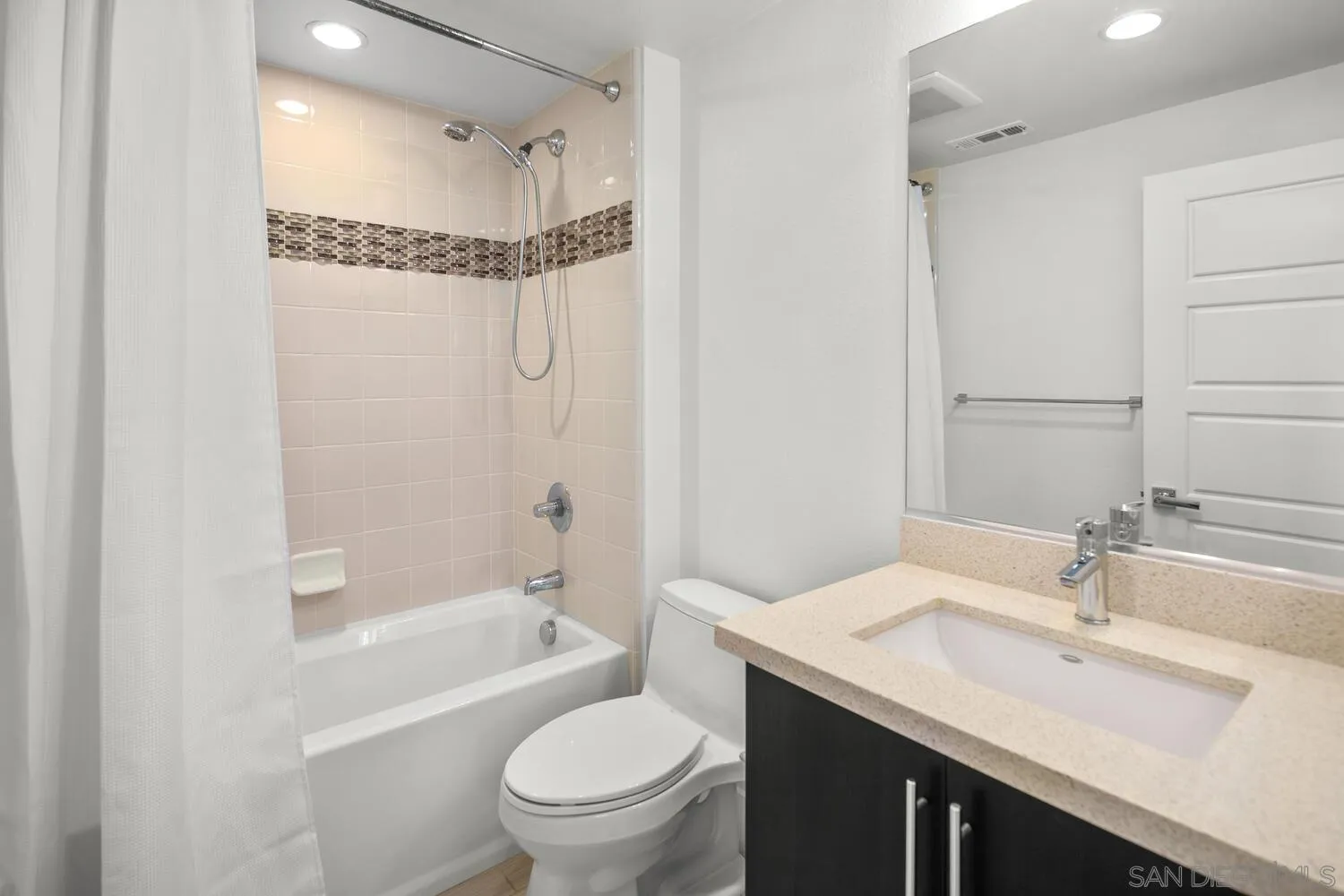 7830 Inception Way San Diego, CA 92108 - Photo 21 of 37 a bathroom with a granite countertop sink a toilet and shower