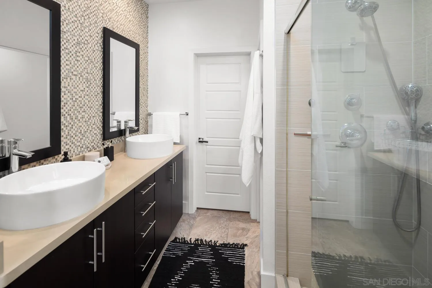 7830 Inception Way San Diego, CA 92108 - Photo 25 of 37 a bathroom with a double vanity sink a toilet and shower