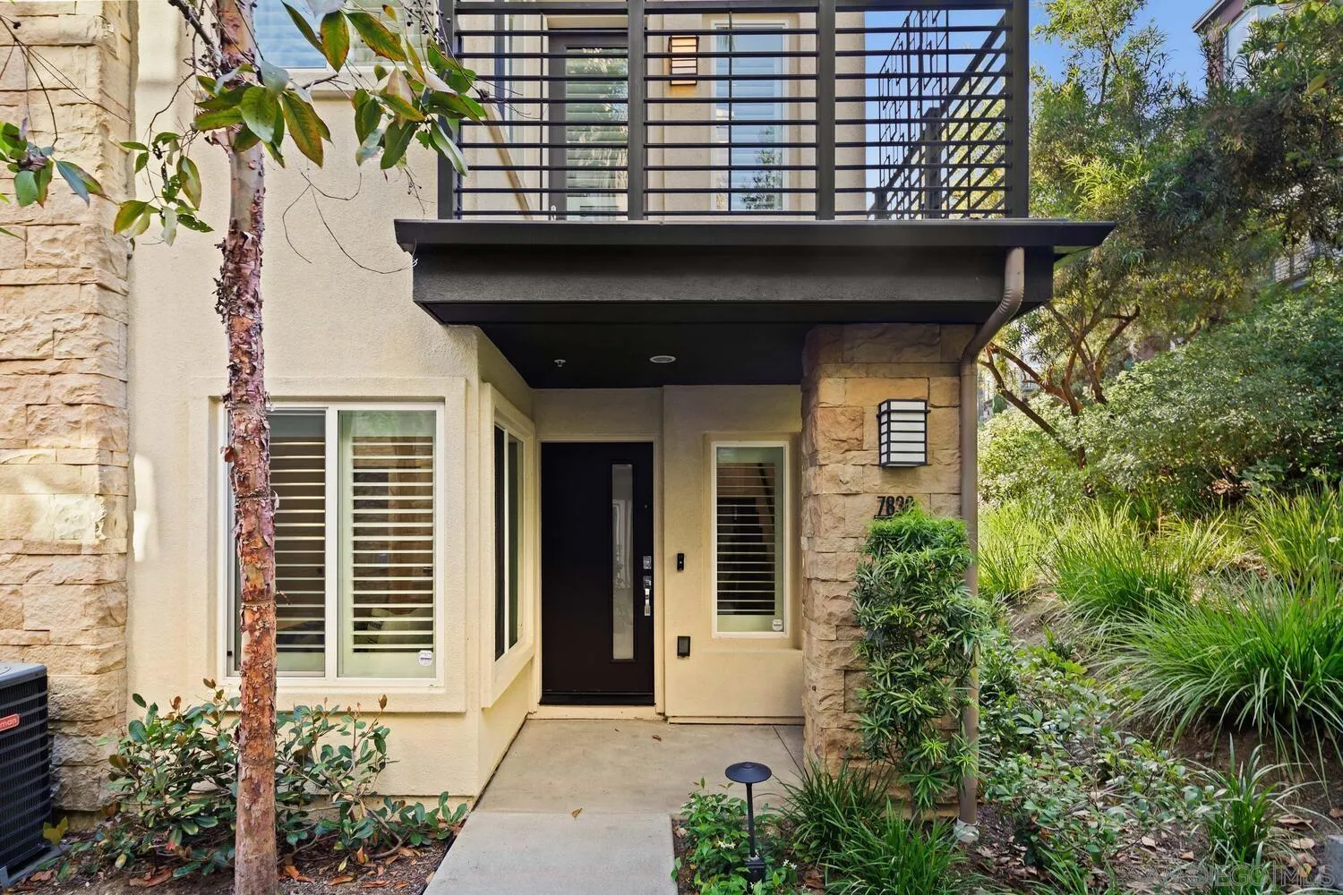 7830 Inception Way San Diego, CA 92108 - Photo 5 of 37 a front view of a house with a yard