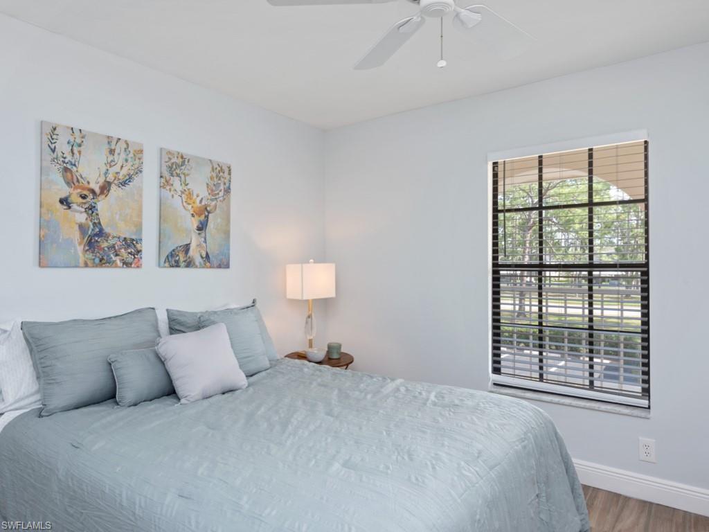 709 Augusta Boulevard, Unit 7095 Naples, FL 34113 - Photo 9 of 16 Bedroom featuring ceiling fan and wood-type flooring