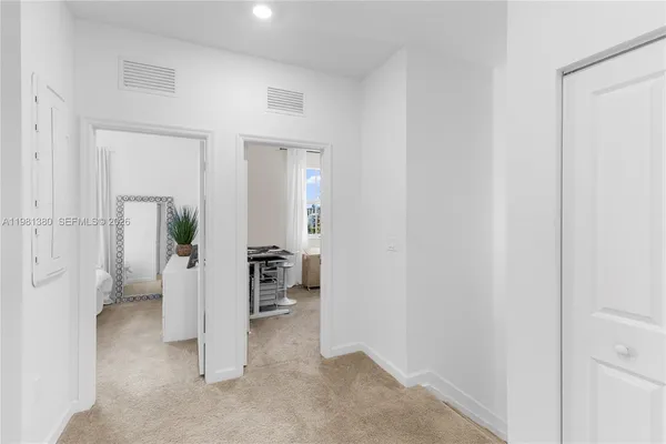 a view of a livingroom and a hallway