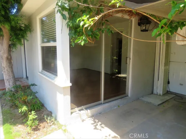 a backyard of a house with lots of green space and glass windows