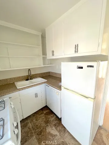 a kitchen with a sink a refrigerator and a stove