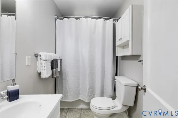 a white toilet sitting next to a bathroom sink