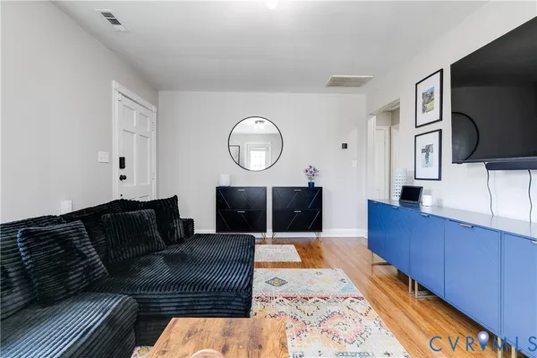 a living room with furniture and a flat screen tv