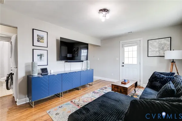 a living room with furniture and a flat screen tv