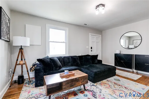 a living room with furniture and a rug