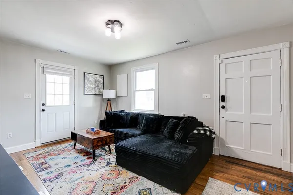 a living room with furniture and a rug