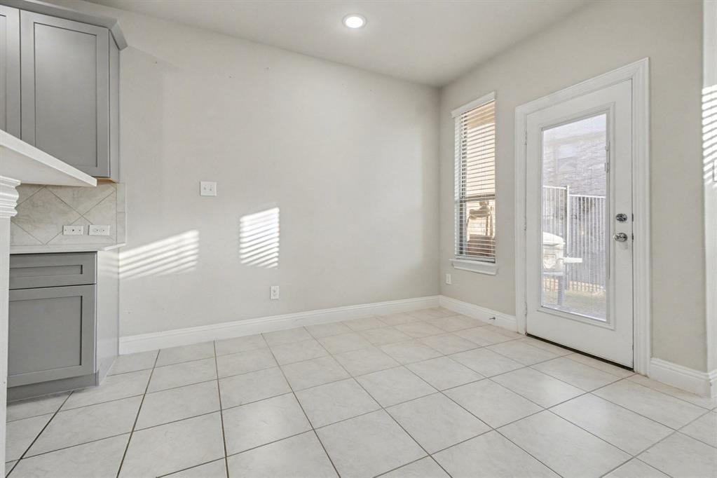520 Teton Street Allen, TX 75002 - Photo 11 of 26 a view of an empty room with window and cabinet area