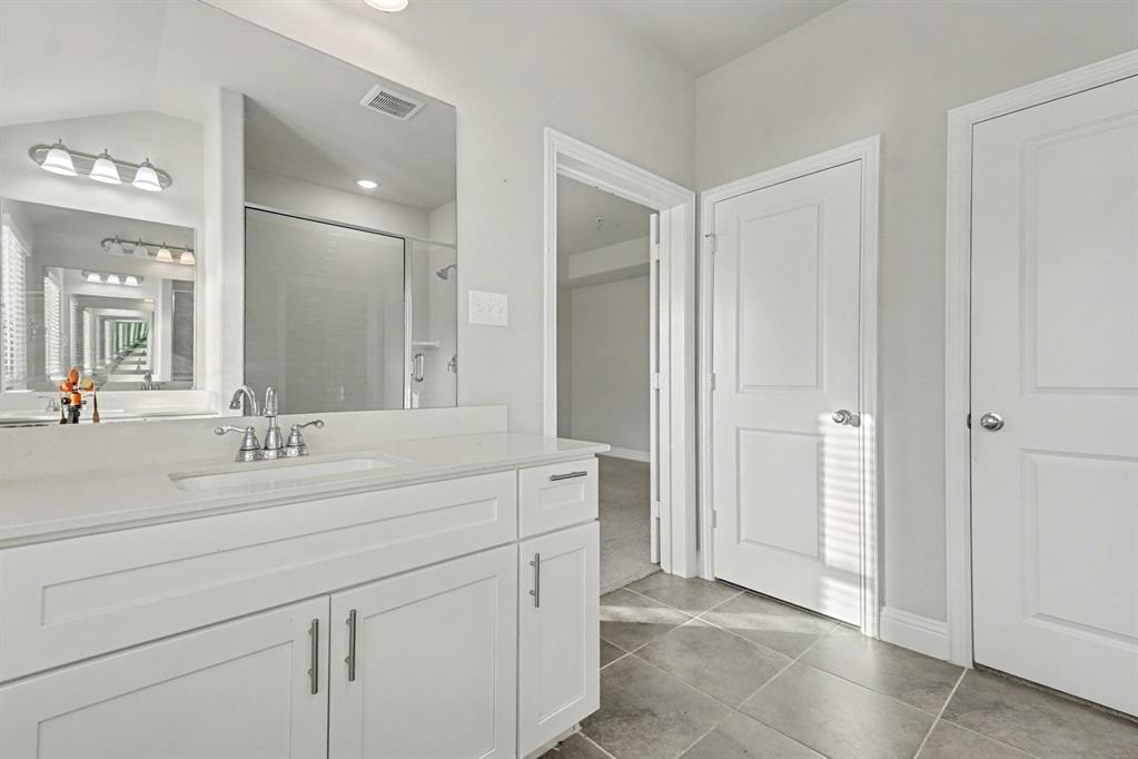 520 Teton Street Allen, TX 75002 - Photo 16 of 26 a bathroom with a sink and a mirror