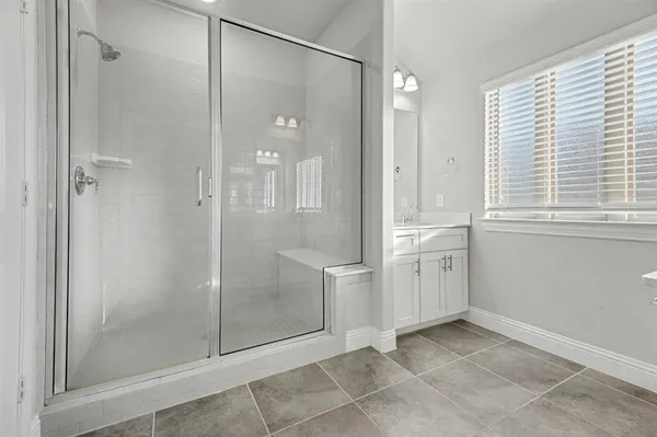 a bathroom with a shower and a sink