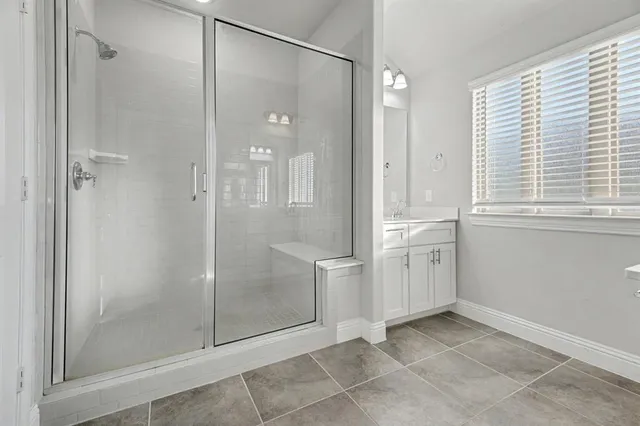 a bathroom with a shower and a sink