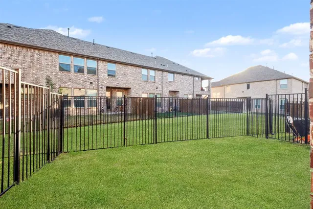 a view of a house with a backyard and porch