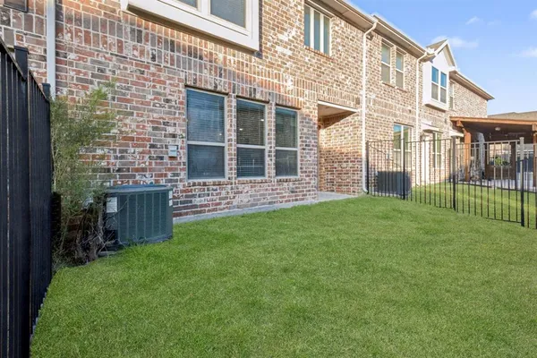 a view of a house with a backyard and porch