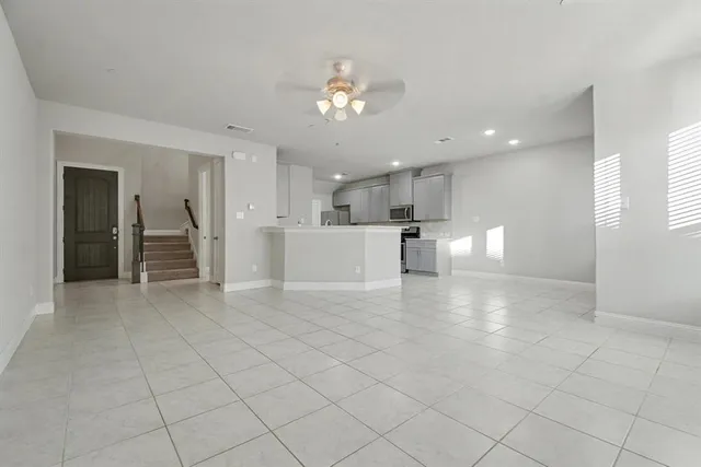 a view of a kitchen with a sink and a refrigerator