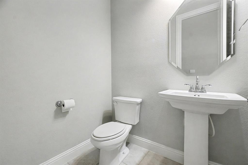 520 Teton Street Allen, TX 75002 - Photo 6 of 26 a bathroom with a sink a toilet and mirror