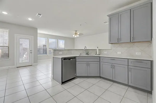 a kitchen with a sink window and cabinets