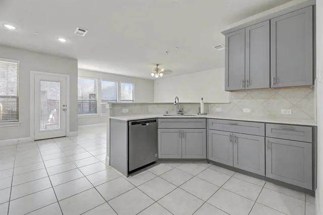 a kitchen with a sink window and cabinets