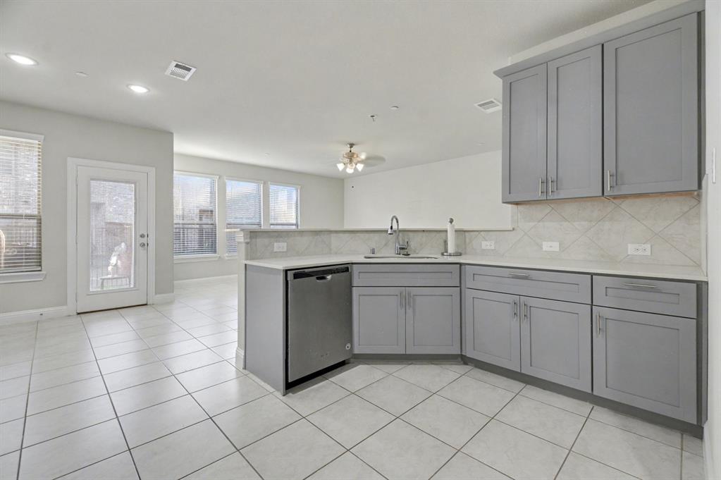 520 Teton Street Allen, TX 75002 - Photo 7 of 26 a kitchen with a sink window and cabinets