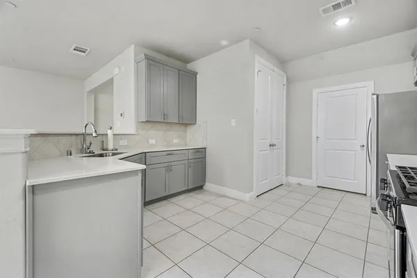 a kitchen with stainless steel appliances a sink and a refrigerator
